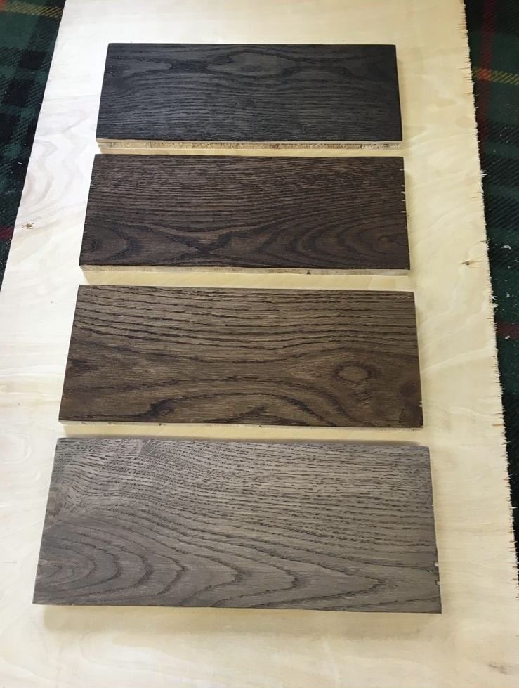 Stained timber sample boards laid out in the workshop