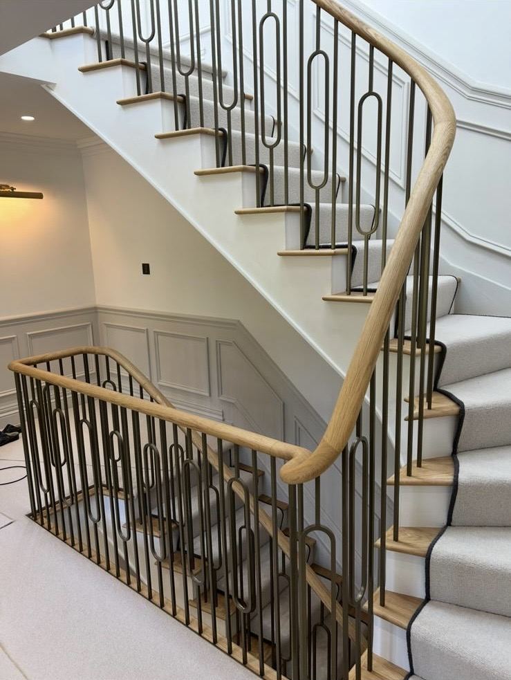 An oak staircase with brass balustrade, fitted on site