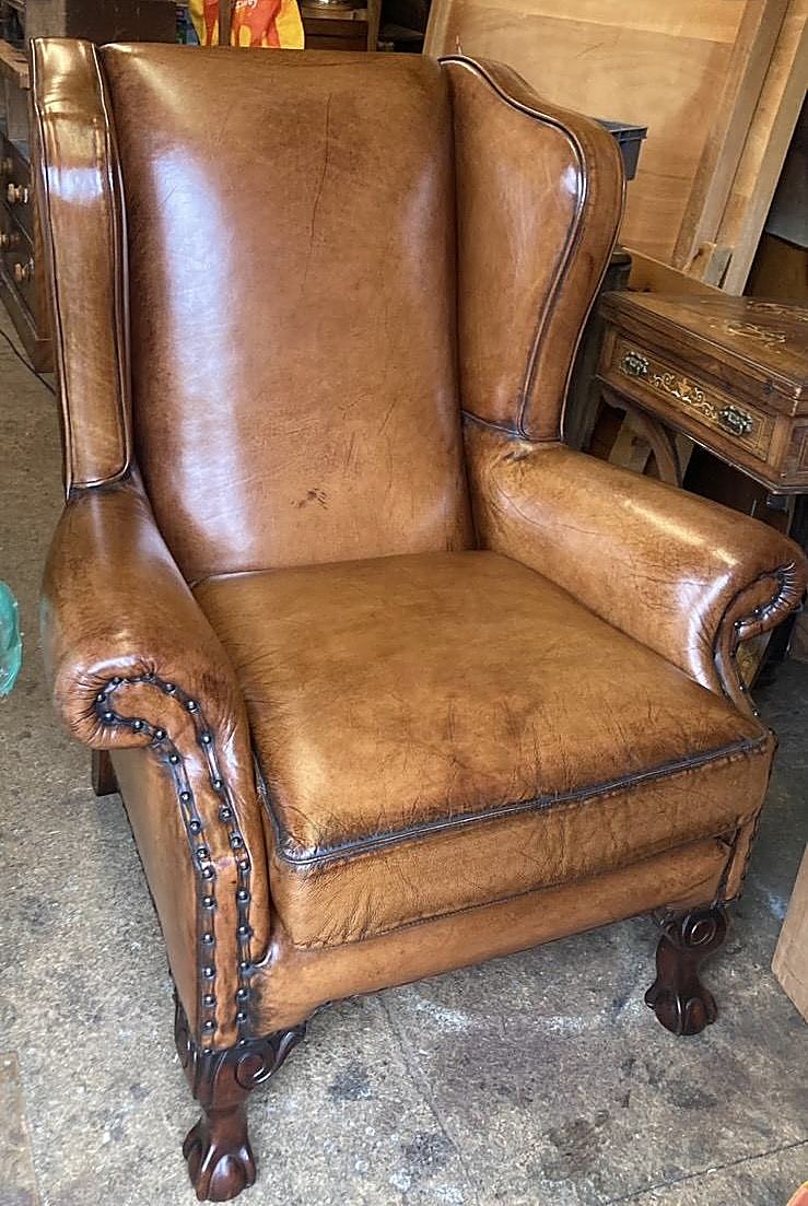 A leather wing chair after re-upholstery